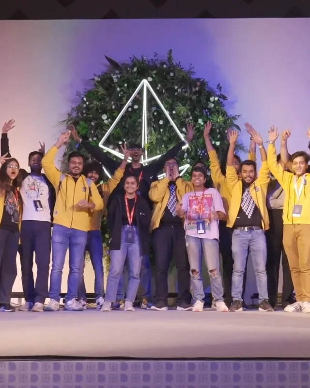 The ETHIndia 2022 organising team in yellow jackets, cheering on stage