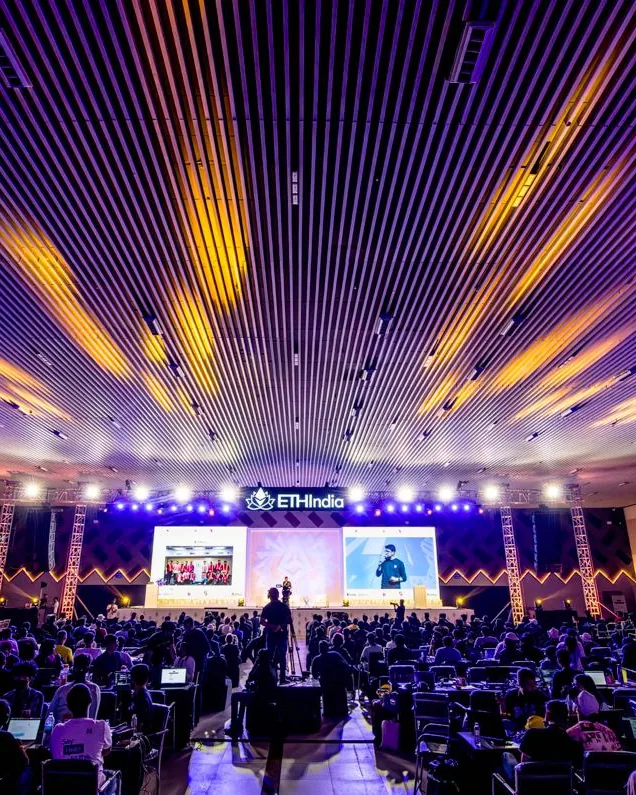 The ETHIndia 2023 auditorium under the lit ceiling, before the opening
