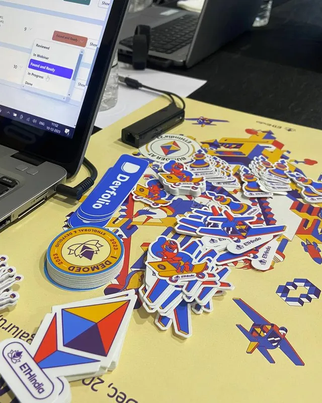 A laptop surrounded by ETHIndia 2023 stickers