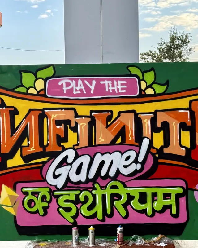 The hand-painted Play the Infinite Game of Ethereum sign at ETHIndia 2024