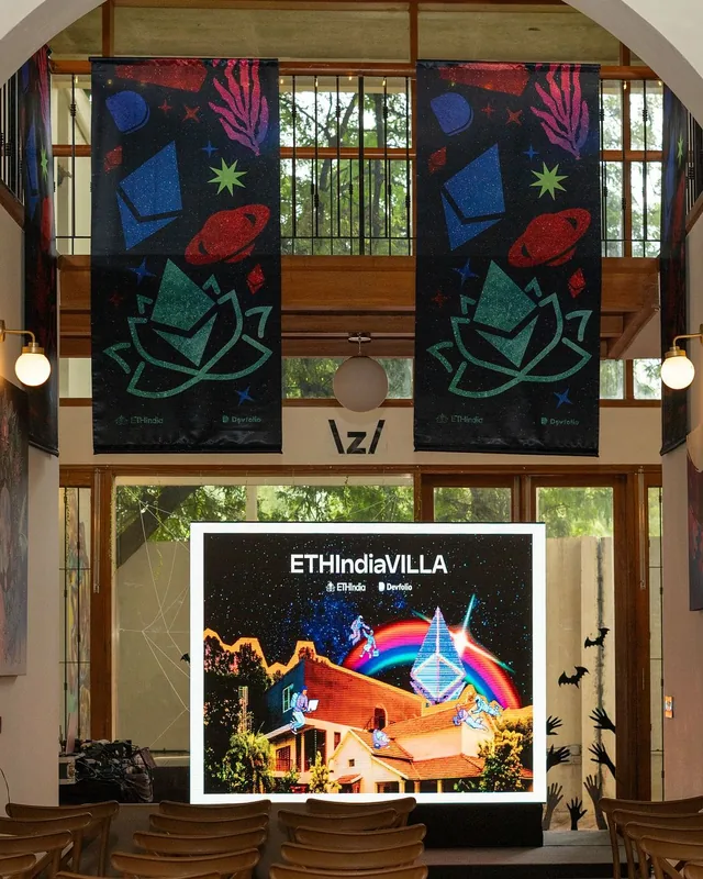 The ETHIndiaVilla hall, with ETHIndia banners and the ETHIndiaVILLA screen, 2025
